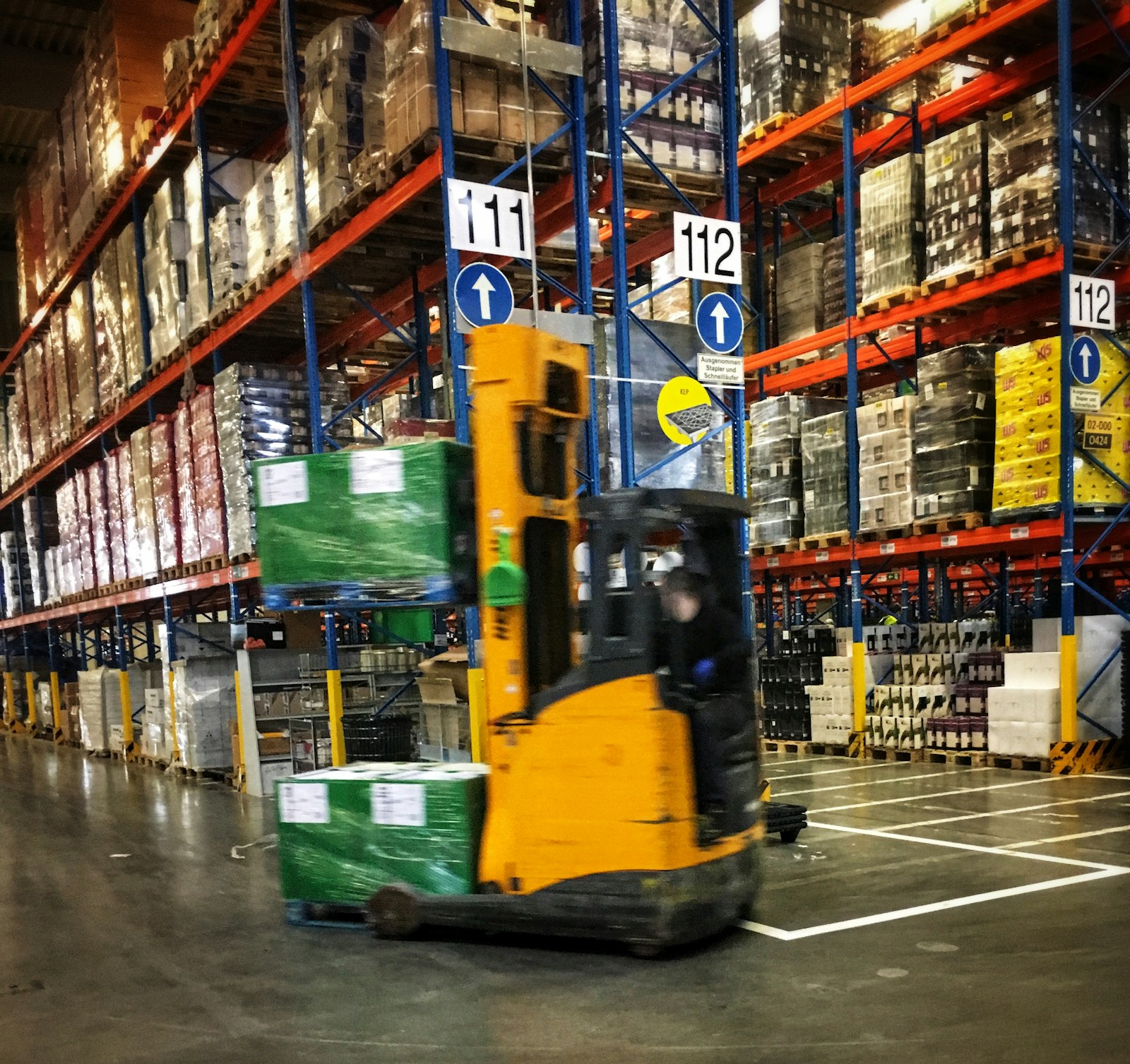 Forklift moving pallets in a warehouse